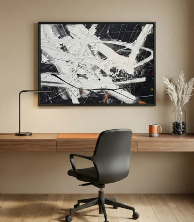 Gestural abstract expressionist hand-painted canvas in dynamic black, white and ochre brushstrokes, modern workspace