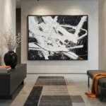 Abstract expressionist hand-painted canvas with dynamic white gestural strokes and black background, contemporary living space