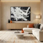Gestural abstract hand-painted canvas in monochrome white and charcoal with dynamic linear marks, contemporary living space