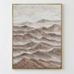 Textured landscape painting depicting layered mountain ranges in warm earth tones and soft cream, hand-painted canvas in contemporary space