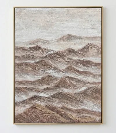 Textured landscape painting depicting layered mountain ranges in warm earth tones and soft cream, hand-painted canvas in contemporary space