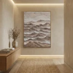 Textured landscape hand-painted canvas depicting layered mountains in warm earth tones and soft grays, contemporary entryway
