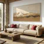 Textured landscape hand-painted canvas depicting snow-capped mountains in warm ochre and cream tones, contemporary living space