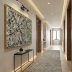 Gestural abstract expressionist hand-painted canvas in black, cream, and earth tones, modern hallway setting