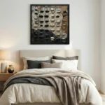 Textured abstract hand-painted canvas in layered blacks, creams, and taupes with dimensional relief elements, contemporary bedroom