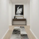 Expressionist hand-painted canvas depicting dynamic white gestural brushstrokes against deep black background, monochromatic palette, modern entryway