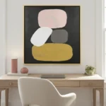 Minimalist abstract hand-painted canvas with stacked organic shapes in blush, cream, charcoal, and mustard, contemporary workspace