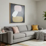 Minimalist abstract hand-painted canvas with stacked rounded forms in soft pink, cream, and ochre tones, contemporary living space