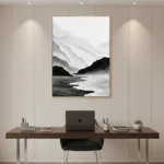 Minimalist landscape hand-painted canvas depicting misty mountains and flowing water in monochrome grey and black tones, modern workspace