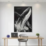 Gestural monochrome hand-painted canvas of a breaching whale with dynamic splashing water, contemporary workspace