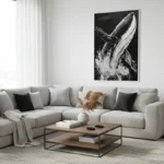 Monochromatic hand-painted canvas depicting a breaching whale with dramatic splashing water and gestural brushwork, contemporary living space