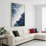 Contemporary landscape hand-painted canvas depicting snow-capped mountains and dramatic cloud formations in deep blue and white tones, modern living space