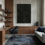 Textured abstract hand-painted canvas with dynamic radiating black brushstrokes on dark background, modern office space