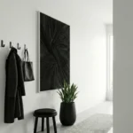 Textured abstract hand-painted canvas with radiating black brushstrokes in monochromatic palette, modern entryway