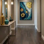 Abstract hand-painted canvas with swirling teal and gold circular forms, contemporary entryway setting