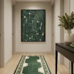 Minimalist abstract hand-painted canvas with interlocking lines and organic shapes in deep forest green and cream, contemporary hallway