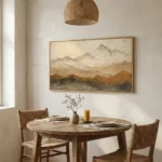 Impressionist landscape hand-painted canvas depicting misty snow-capped mountains in muted earth tones and creams, dining space