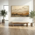 Impressionist landscape hand-painted canvas depicting misty snow-capped mountains in soft ochre and cream tones, contemporary entryway