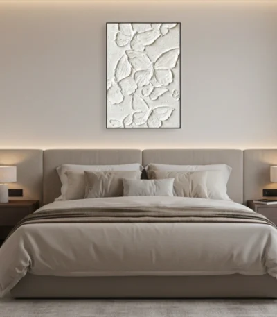 Textured abstract hand-painted canvas with layered white botanical relief forms in monochrome, modern bedroom setting