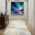 Impressionist hand-painted canvas depicting aurora borealis over frozen lake with pine forest, blues purples and yellows, contemporary hallway