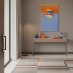Figurative hand-painted canvas of a colorful fish in orange and blue tones, contemporary entryway