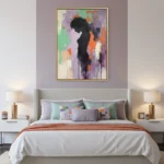 Abstract expressionist hand-painted canvas depicting a silhouetted figure in black with vibrant gestural strokes in purple, green, orange, and cream, modern bedroom