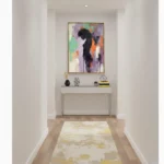 Gestural abstract expressionist hand-painted canvas with bold black silhouette and vibrant multicolored brushstrokes in purple, orange, and green, contemporary entryway
