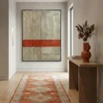 Minimalist abstract hand-painted canvas with bold terracotta stripe across textured cream and sage tones, modern entryway