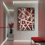 Abstract expressionist hand-painted canvas with white geometric lines on deep red and black, contemporary interior