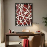 Gestural abstract hand-painted canvas with dynamic white linear marks over deep red and black, contemporary office space