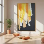 Gestural abstract hand-painted canvas with layered yellow, orange, and cream drips against charcoal background, contemporary studio setting