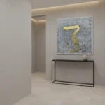 Minimalist hand-painted canvas with bold gold serpentine brushstroke on textured grey background, contemporary entryway