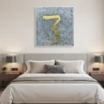 Minimalist hand-painted canvas featuring a textured serpentine gold form on weathered grey background, modern bedroom