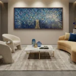 Textured hand-painted canvas depicting a luminous tree with gold leaf branches and blue night sky, contemporary living space