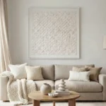 Textured minimalist hand-painted canvas in monochromatic cream tones with dimensional grid pattern, contemporary living space