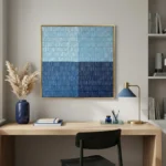 Minimalist abstract hand-painted canvas with horizontal striped texture in layered light and deep blues, contemporary workspace