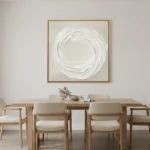 Minimalist abstract hand-painted canvas with gestural white circular brushstrokes on cream ground, contemporary dining space