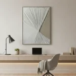Minimalist abstract hand-painted canvas with radiating linear patterns in monochrome greys and whites, contemporary workspace