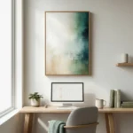 Abstract hand-painted canvas in layered teal, cream, and sage tones with gestural brushwork, modern workspace