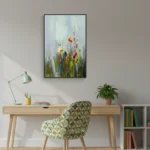 Impressionist hand-painted canvas depicting wildflower meadow in soft grays, yellows and reds, contemporary workspace