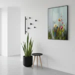Impressionist hand-painted canvas of wildflowers in soft greens, yellows and reds with gestural brushwork, contemporary interior