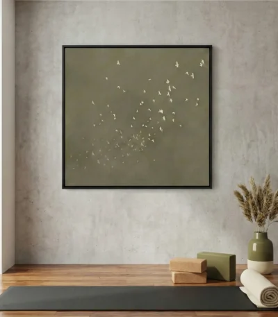 Minimalist hand-painted canvas depicting a flock of birds in flight against muted sage and cream tones, yoga studio setting