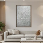 Textured abstract hand-painted canvas in monochromatic grays and whites with gestural brushwork, modern living space