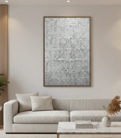 Textured abstract hand-painted canvas in monochromatic grays and whites with gestural brushwork, modern living space