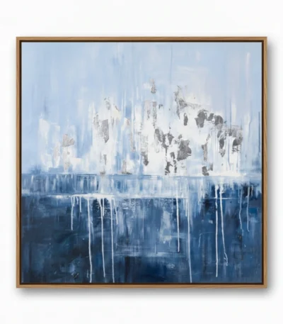 Layered abstract hand-painted canvas with dripping white and grey forms over deep blue tones, contemporary living space