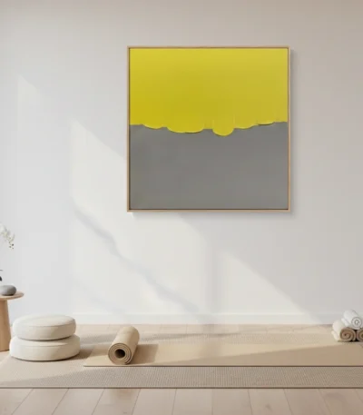 Minimalist abstract hand-painted canvas with yellow sky and grey horizon in soft, muted tones, styled in contemporary space