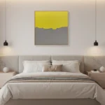 Minimalist abstract hand-painted canvas with divided color fields in chartreuse yellow and muted grey, contemporary bedroom