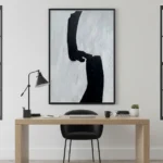 Minimalist hand-painted canvas with bold black gestural brushstrokes on white, contemporary office space