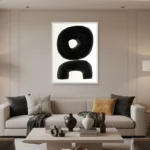 Minimalist abstract hand-painted canvas with bold black organic shapes and negative space on cream, contemporary living space