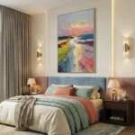 Gestural abstract landscape hand-painted canvas depicting coastal vista in vibrant pink, yellow, and blue tones, modern bedroom setting